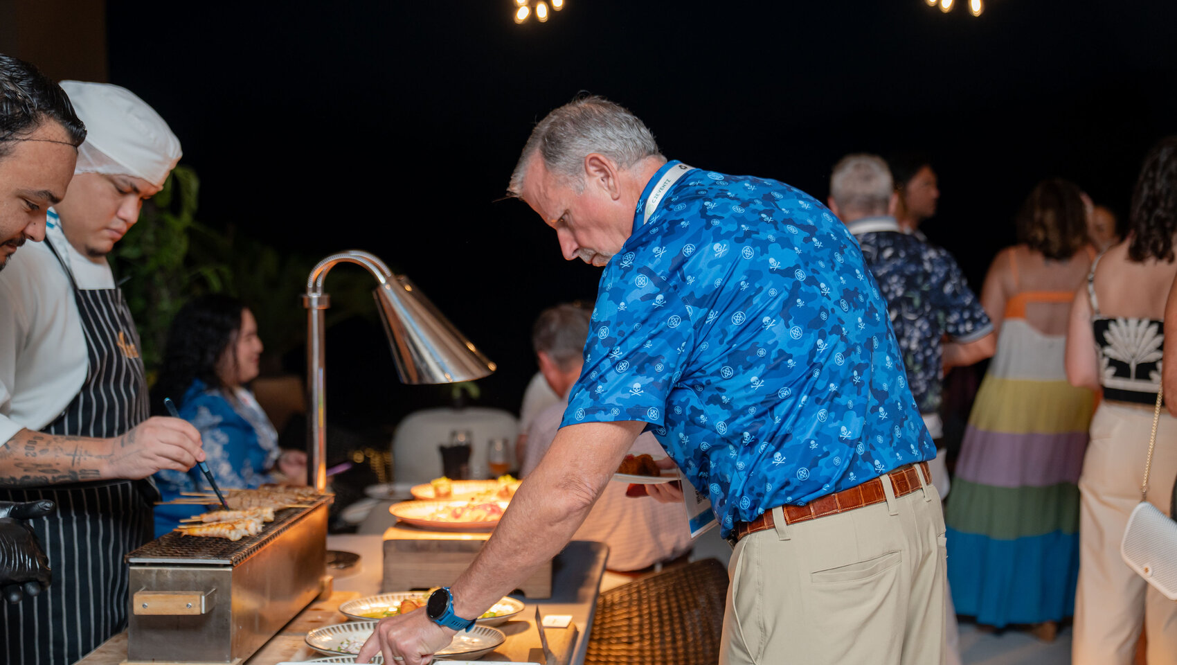 Guest samples food at Beer Festival at Grand Roatan
