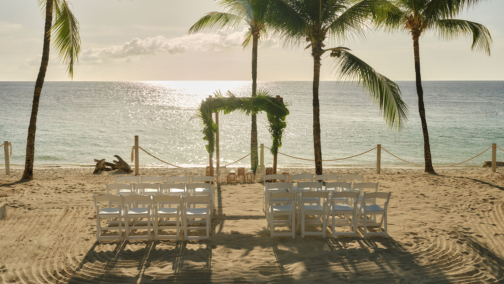 Roatan beach wedding with tropical arbor overlooking ocean