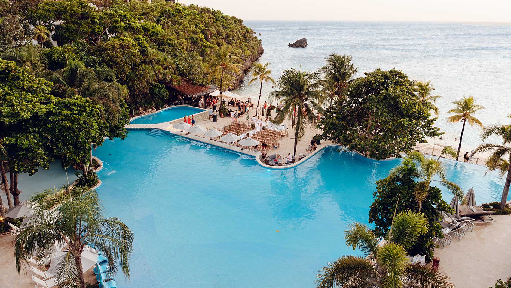 Outdoor ceremony set-up at Kimpton Grand Roatan between pool and beach