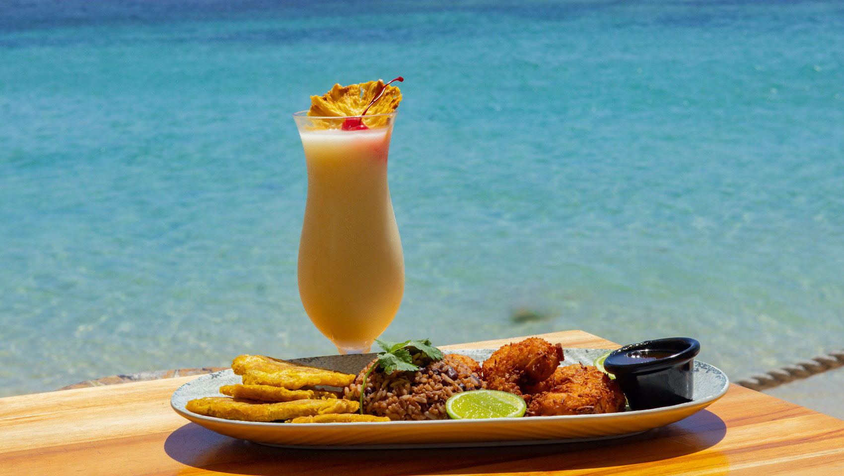 Sea Cat meal and drink in front of ocean