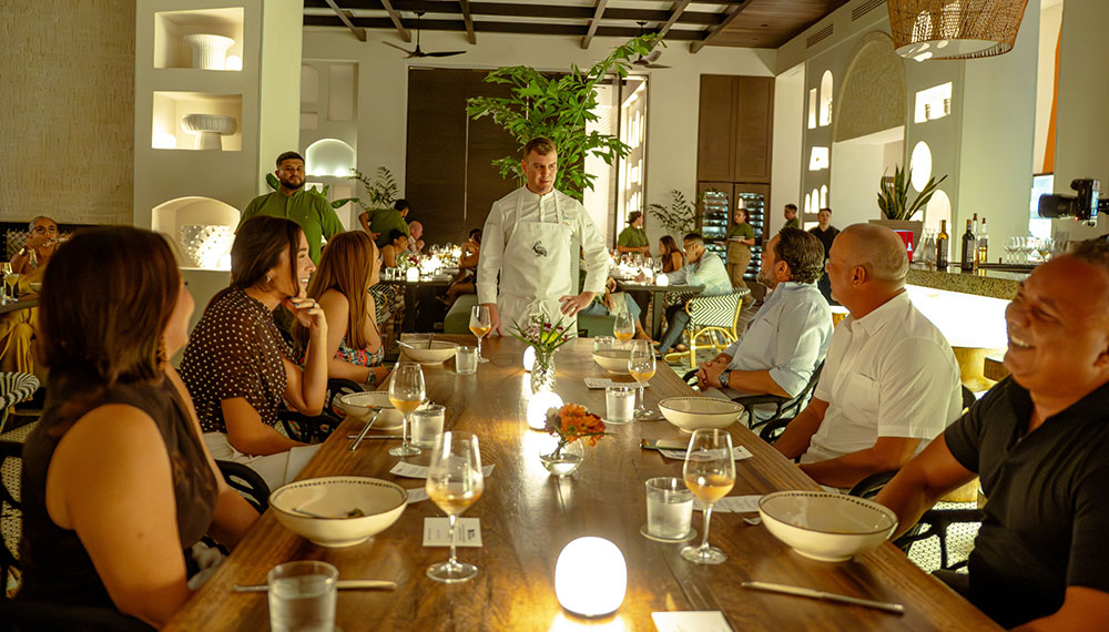 Chef addresses diners during a Guest Chef Series event