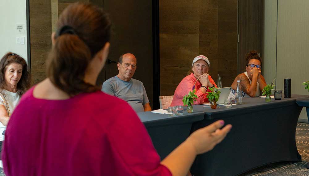 Body scrub creation instructor addresses the group at Kimpton Grand Roatan