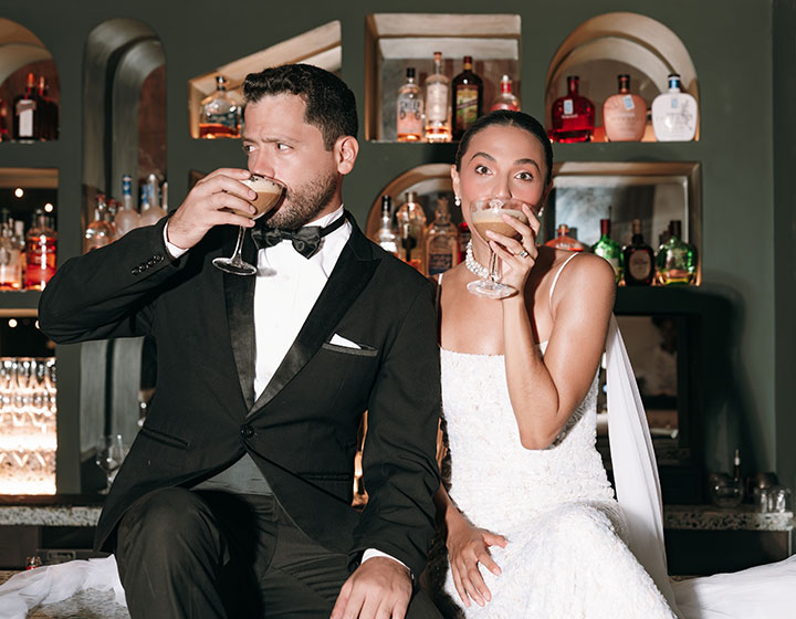Bride and Groom sip cocktails on the bar at Kimpton Grand Roatan 