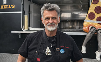 Chef Danilo Ferraz in front of a food truck