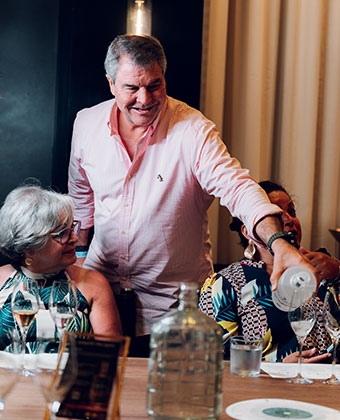 Man pouring for guests from bottle