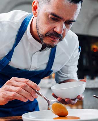 Chef Guido Ojeda plates a dish at Kimpton Grand Roatan