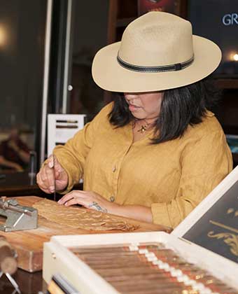 Woman assembling a cigar