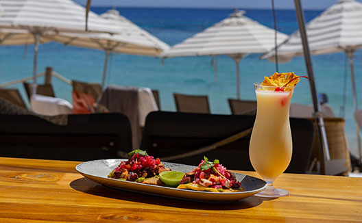 tropical drink + tostada dish at sea cat