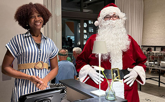 woman standing with Santa Claus at Alera entrance
